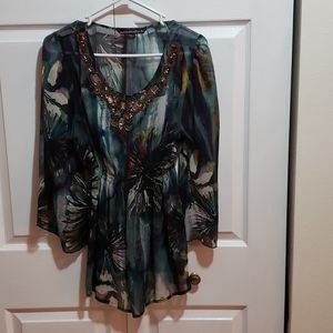 Jeweled neck sheer blouse. Pinched waist. Sheer material, multi blue colors